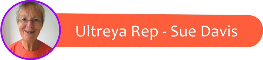 Circular portrait of a smiling older woman with short gray hair in an orange shirt, purple border, beside an orange rounded banner reading 'Ultreya Rep - Sue Davis'