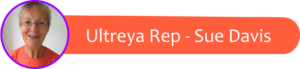 Circular portrait of a smiling older woman with short gray hair in an orange shirt, purple border, beside an orange rounded banner reading 'Ultreya Rep - Sue Davis'